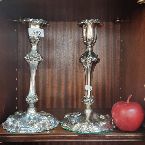 569 - A pair of large  fabulous Georgian profusely decorated  candle sticks, with wide decorated base. In ... 