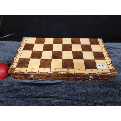 172 - A lovely large two toned wooden complete chess set, with hand carved pieces and presented in a porta... 