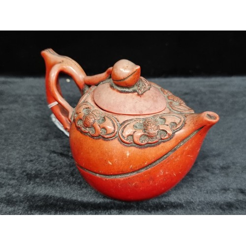 188 - A charming 19th century red cinnabar teapot with a whimsical design of bats and a handle in the form... 