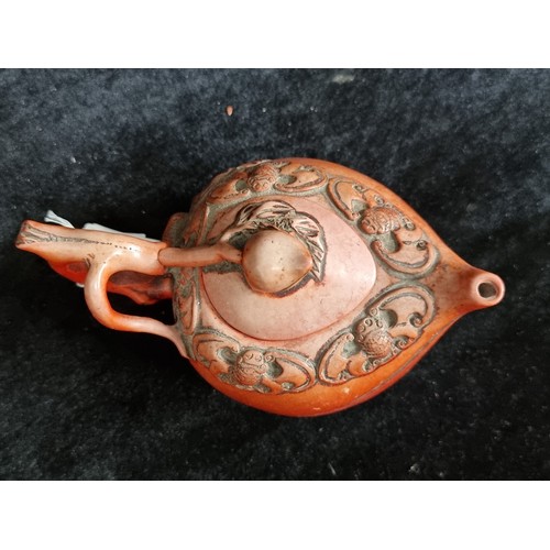 188 - A charming 19th century red cinnabar teapot with a whimsical design of bats and a handle in the form... 