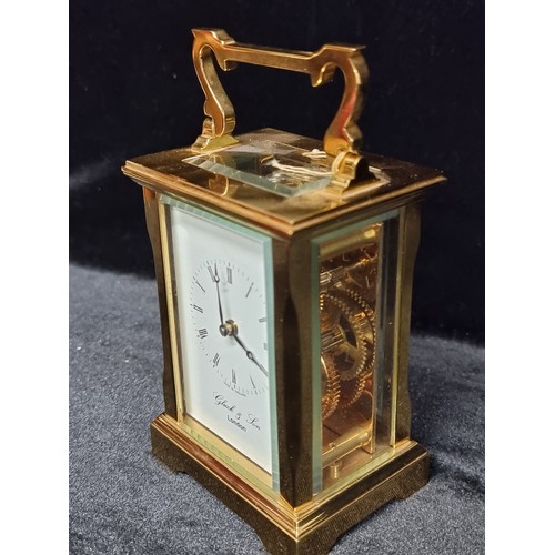 241 - A heavy brass antique carriage clock by David Peterson with bevelled glass. With  exposed fly wheel ... 