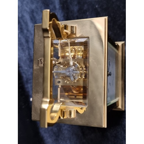 241 - A heavy brass antique carriage clock by David Peterson with bevelled glass. With  exposed fly wheel ... 