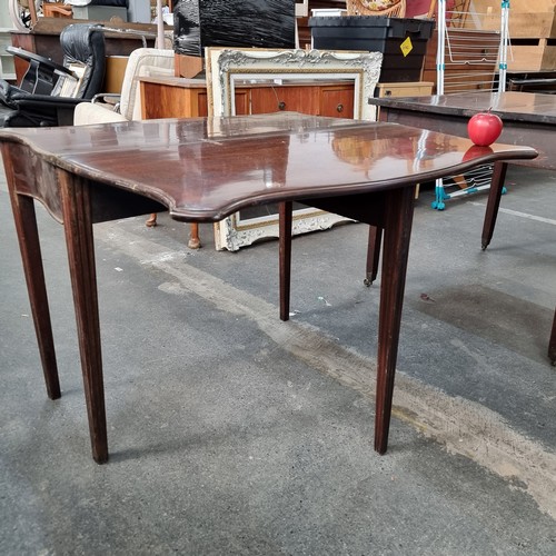 362 - Two Edwardian mahogany tables including a serpentine fronted example. Both with folding table tops a... 