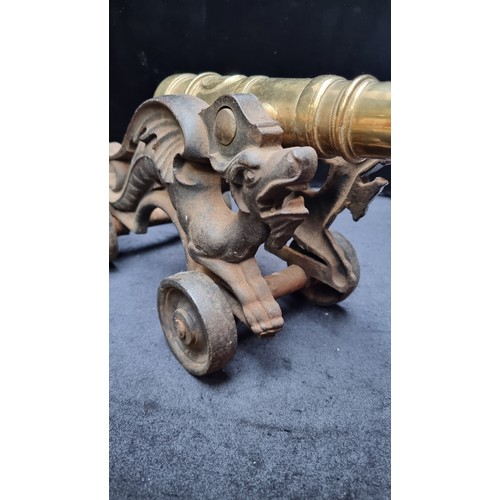 394 - Star Lot : A very heavy large Mid Victorian brass table cannon on a cast iron wheeled carriage in th... 