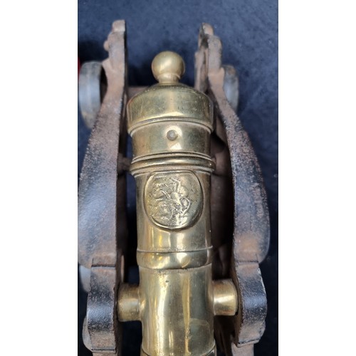 394 - Star Lot : A very heavy large Mid Victorian brass table cannon on a cast iron wheeled carriage in th... 