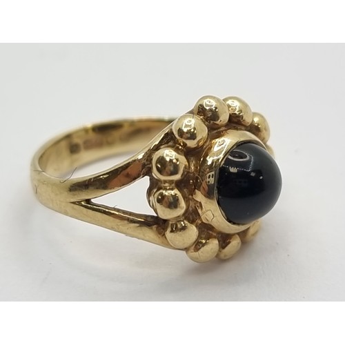 411 - An attractive 9K gold raised cabochon set stone ring. Ring size F, weight 3.1g.