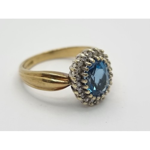 412 - A 9K gold diamond and topaz stone cluster ring. Ring size K, weight 3.7g. Stones very bright, a good... 