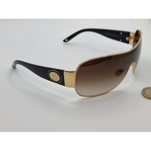 421 - A good pair of original  Versace, made in Italy, wraparound style sunglasses. Lenses in good order. ... 