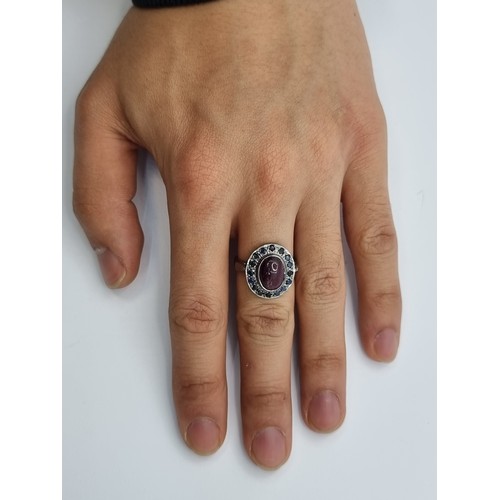 455 - An attractive ruby and sapphire ring. Weight of ruby 3cts, sapphires amount to 0.35cts in total. Rin... 