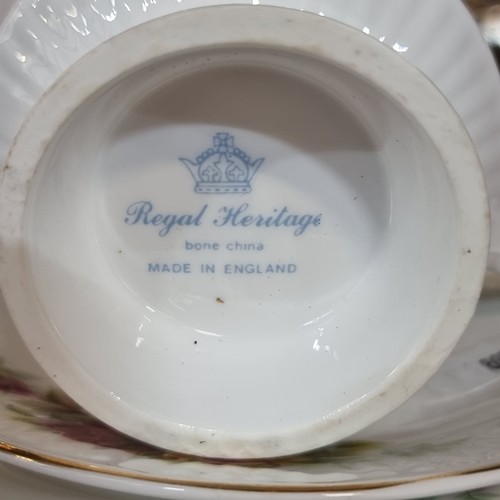 591 - Twenty one pieces of Royal Heritage china with a charming rose pattern.