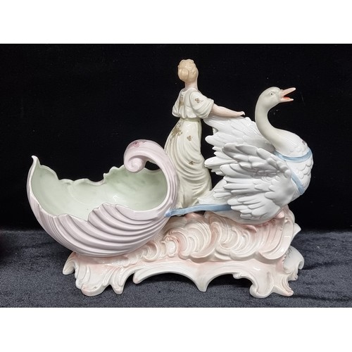 113 - A highly ornate antique porcelain sculptural piece depicting an elegant lady riding a swan carriage,... 