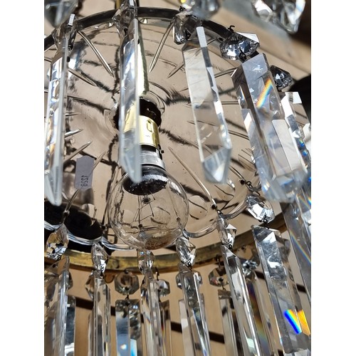 335 - A vintage Art Deco style chandelier with a brass frame, cut glass drop prism and tear drop pendants.... 