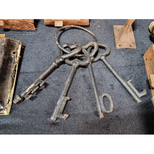 511 - A mixed lot of cast metal items including antique door handles, fittings with original keys, ceramic... 