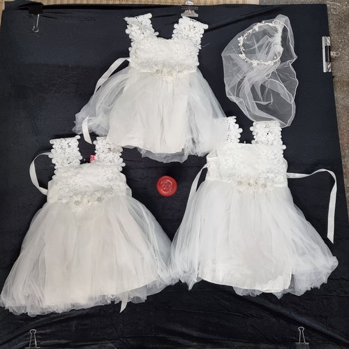 608 - A collection of seven brand new white  dresses for children aged 6 mths to 2 yrs. With lovely exampl... 