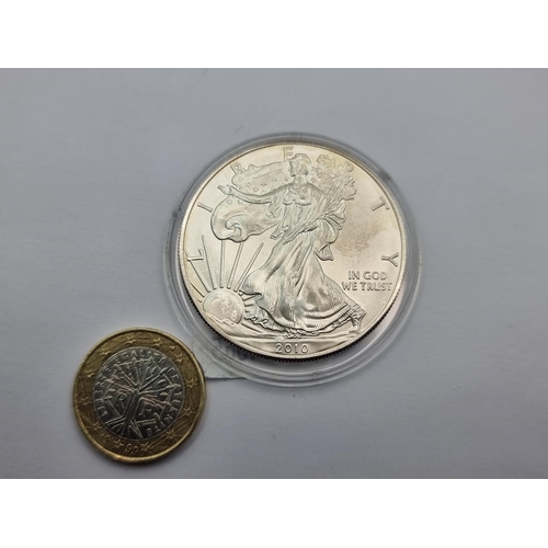 1 - A US one ounce fine silver dollar coin. Dated 2010. In Mint condition.