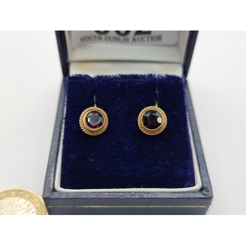 2 - An attractive pair of 9K gold garnet set clasp earrings. Total weight of earrings 2.2g.