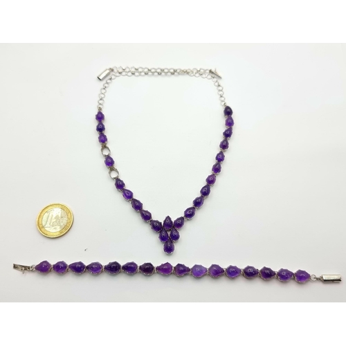 28 - A suite of amethyst stone set items, consisting of a drop pendant necklace and bracelet. Length of n... 
