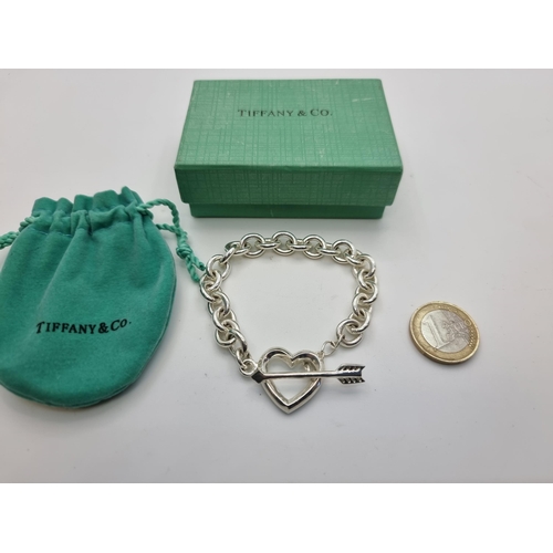 50 - A sterling silver Tiffany T-bar heart bracelet, with original box and draw string bag.