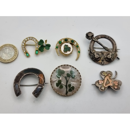 55 - A collection of six Irish brooches, four with shamrock design. Of interest a sterling silver and gol... 