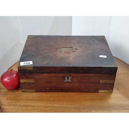 754 - An antique mahogany portable travel writing desk with felt interior lining, and multiple storage com... 