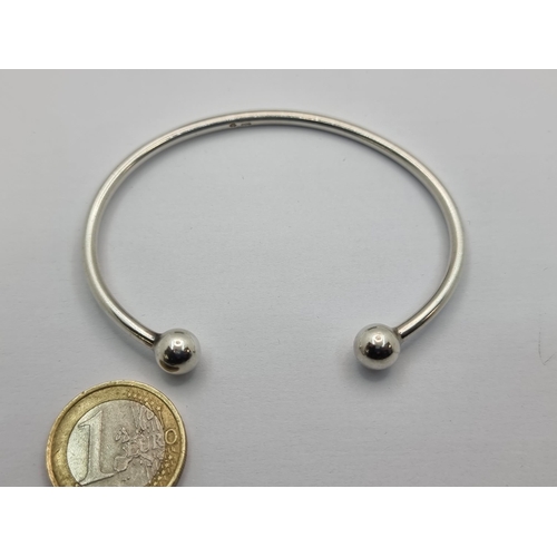 8 - A sterling silver torc bracelet, width 7cm, weight 13.2g.