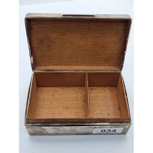 34 - A sterling silver cigarette box with engine turned lid and figural inlay. Hallmarked London 1930, ma... 
