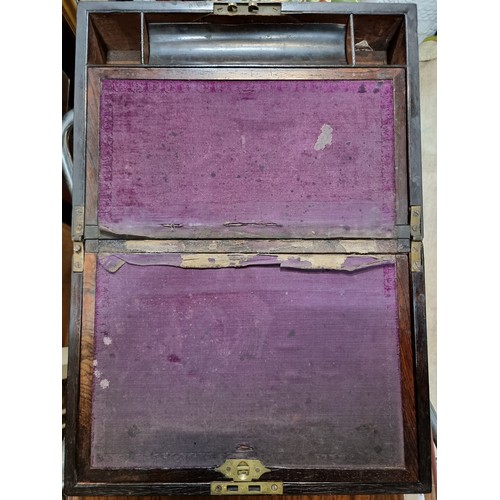 754 - An antique mahogany portable travel writing desk with felt interior lining, and multiple storage com... 