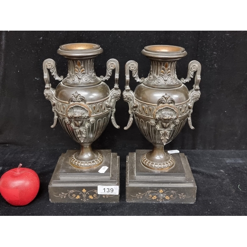 139 - Star lot : A very heavy pair of Victorian bronze urns, lavishly decorated in the classical Greek sty... 