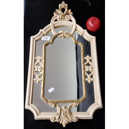 157 - A Neoclassical style wall mirror with gilded internal border, and cream toned frame topped with a st... 