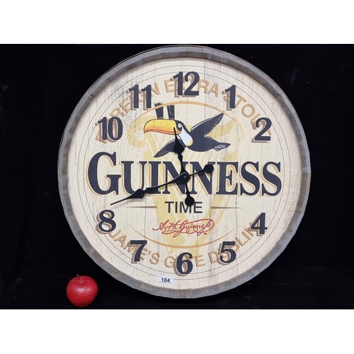 184 - A large Guinness Advertising wall clock, in the style of a cooper's barrel top. Battery operated, wi... 