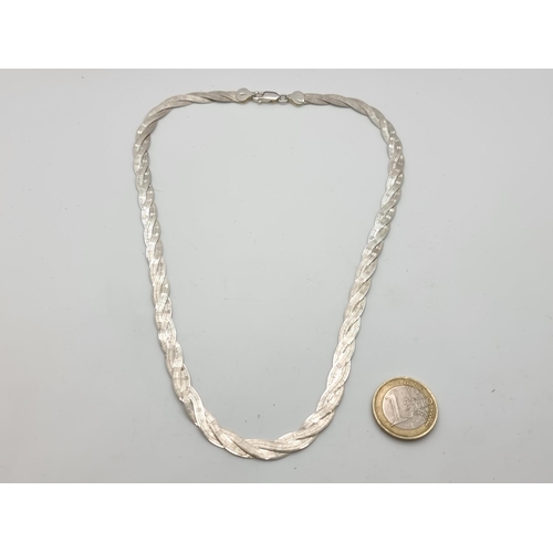 766 - A Sterling Silver twist design flat chain.