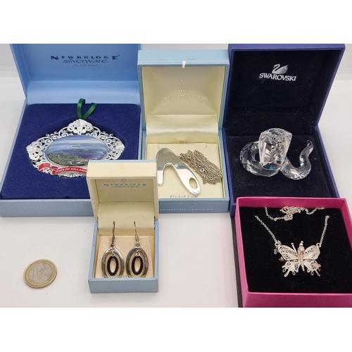 33 - A nice collection of five items, including a Swarovski Glass Cobra, a pretty butterfly set pendant n... 