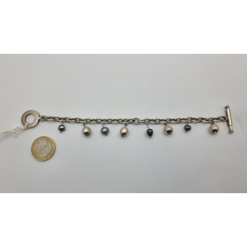 36 - A heavy sterling Silver bracelet with natural pearls and balls with a pandora style clasp. Weight: 2... 