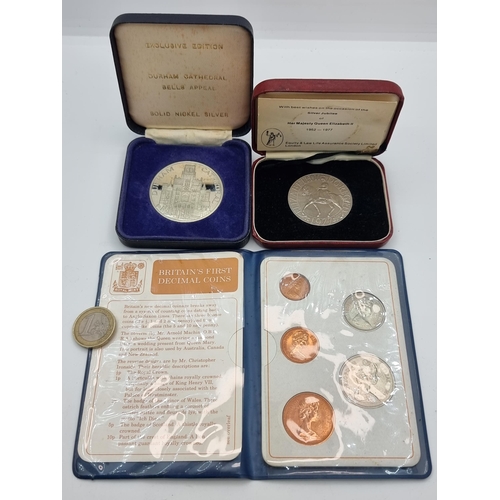 53 - A collection of three items, including a wallet containing five British first decimal coins, a Queen... 