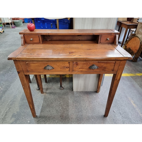 A lovely cherry wood writing desk featuring two drawers to the front