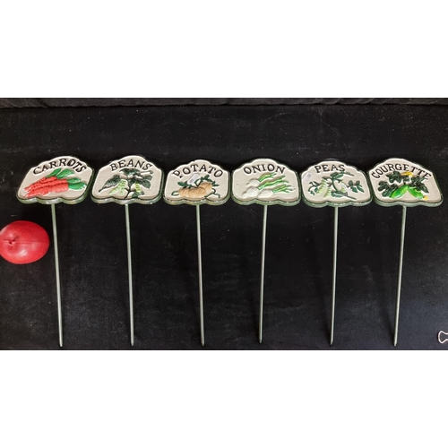 173 - A set of six cast metal vegetable patch signs including courgettes, onions, potatoes, peas, beans an... 