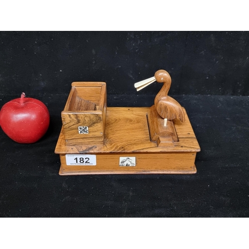 182 - A vintage cigarette dispenser box with inlaid ivorine detail and polished bird figure. In great work... 