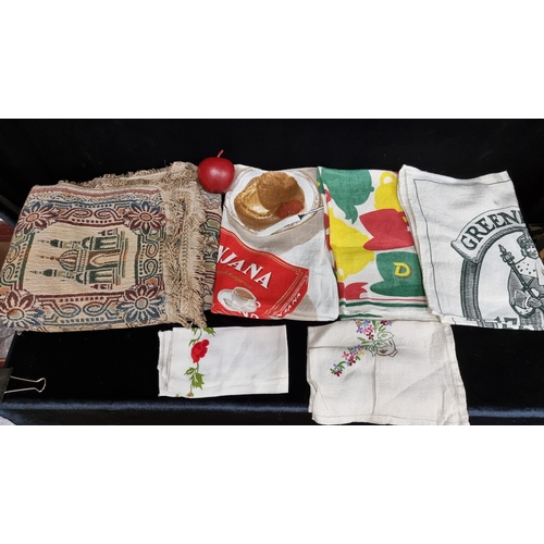 222 - A selection of six textile pieces including branded advertising items such as a Punjana brand tea-to... 