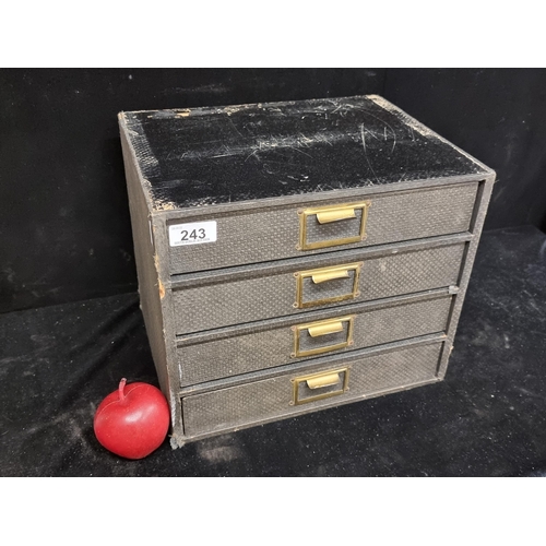 243 - A vintage desktop four tray filing chest, made of wood and covered in a woven charcoal fabric. Finis... 