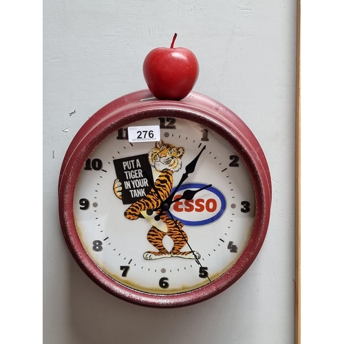 276 - A deep red circular wall hanging clock advertising Esso reading 