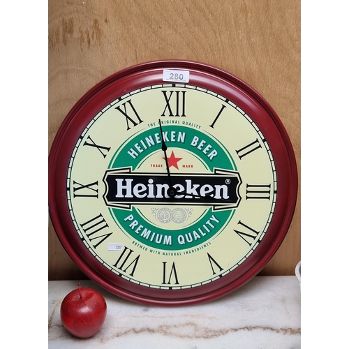 280 - A metal advertising wall clock for Heineken. Battery operated and diameter 40cm.