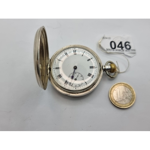 46 - A pocket watch marked Britannia silver. With white enamel face, Roman numeral dial and embossed init... 