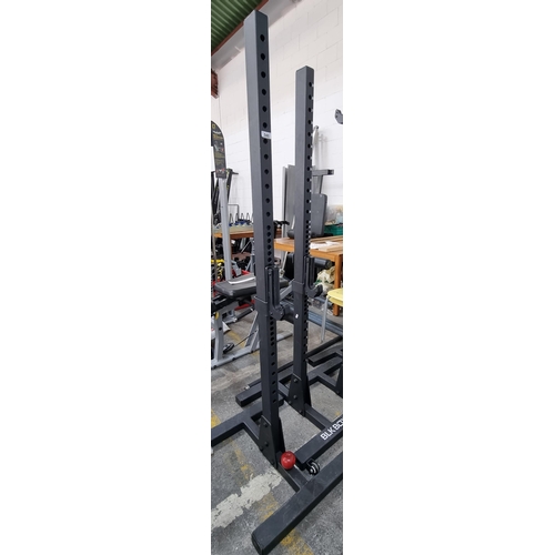 546 - A pair of Commercial gym quantity adjustable Height half racks by 'BLKBOX' in black. On casters.