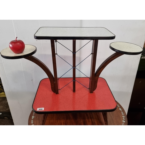 608 - A very cool mid-century 1950s four tier plant stand, with a oak wood frame and a mottled effect red ... 