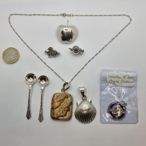 724 - Nine sterling silver items including a Segal & Son 1944 Dublin medal, a conch shell pendant from Mex... 