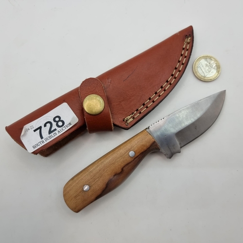 728 - A South African Biltong knife with three inch blade, wooden handle and leather holster.