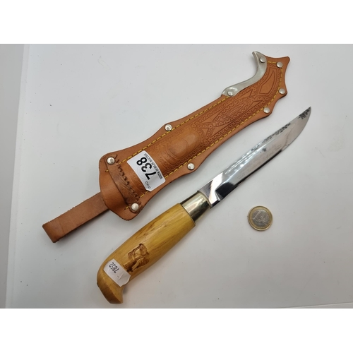 738 - A Finnish made 6'' hunting knife in a beautiful embossed genuine leather holster. Made by a famous F... 