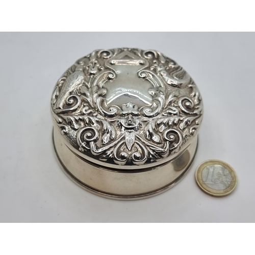 741 - A sterling silver, velvet lined ring box. With Rococo designed hinged lid. Hallmarked Birmingham 192... 