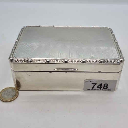 748 - A sterling silver dual cigarette box. Hallmarked London, maker and date marks indistinct. Finished w... 