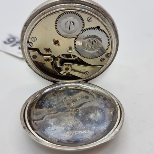 46 - A pocket watch marked Britannia silver. With white enamel face, Roman numeral dial and embossed init... 